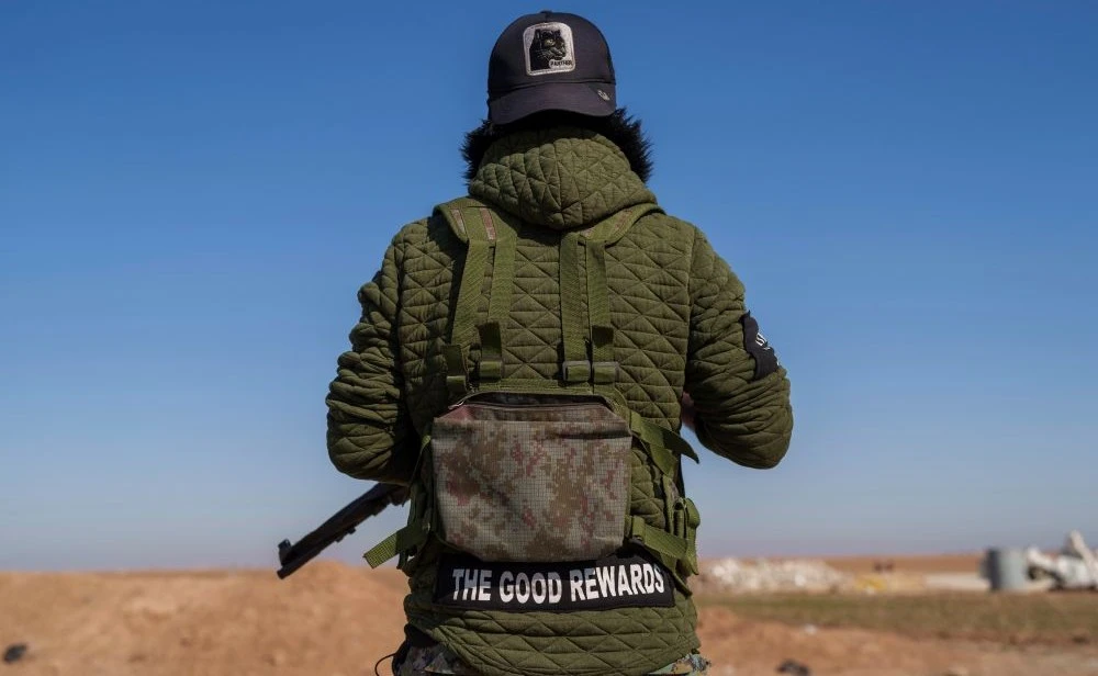 A Syrian Democratic Forces fighter secures a road in Daoudiya, Hassakeh province, Syria, Wednesday, Jan. 29, 2025. (AP Photo)