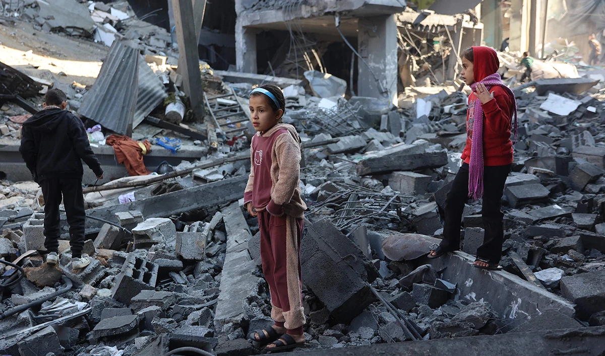 Palestinian children inspect the damage at the site of an Israeli strike the previous night, in Jabalia, in the central Gaza Strip on January 1, 2025, as the war between Israel and Hamas continues. (AFP)