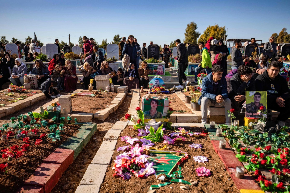 Mourners attend the funeral in Qamishly of two Kurdish Syrian Democratic forces fighters, killed days earlier in battle with Turkish-backed Syrian forces in the northern city of Manbij, on January 2, 2025. (AFP)