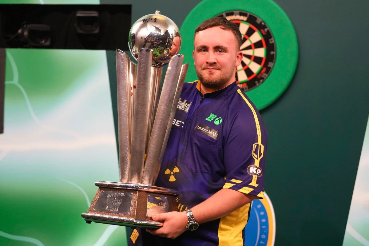 Luke Littler of England with the trophy after winning the final against Michael van Gerwen of the Netherlands at the World Darts Championship at Alexandra Palace in London Friday. (AP)