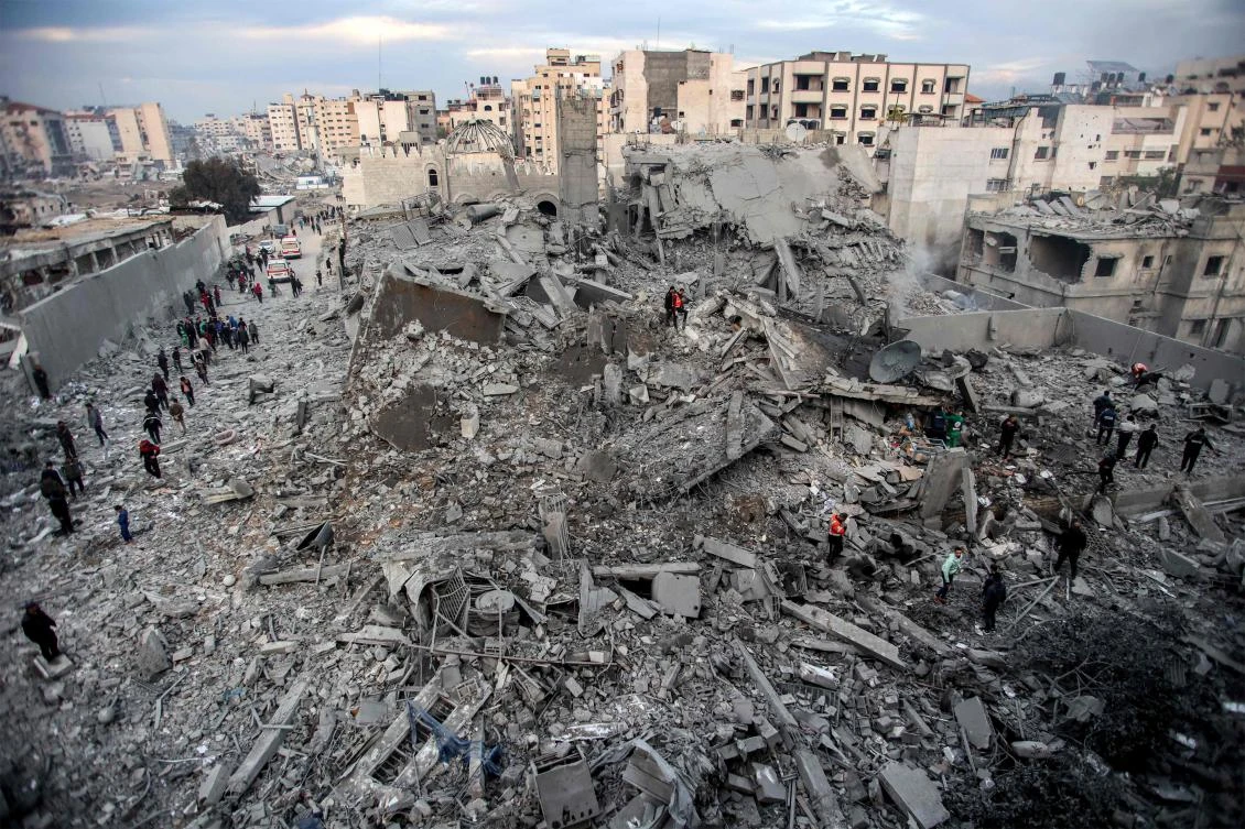 People and first responders inspect the rubble of a collapsed residential building that was hit by Israeli bombardment in the Saraya area in Al-Rimal in central Gaza City on January 4, 2025. (AFP)