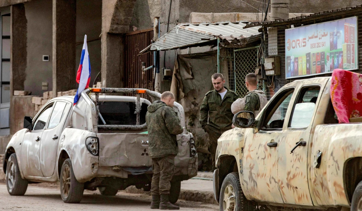Russian soldiers stand by military pickups as they prepare to evacuate a position in Qamishli in northeastern Syria on December 12, 2024. (AFP)