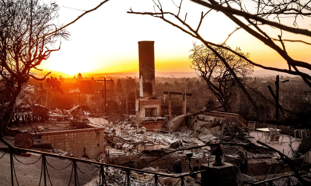The sun rises behind a home destroyed by the Palisades Fire in the Pacific Palisades community of Los Angeles on Sunday, Jan. 12, 2025. (AP)