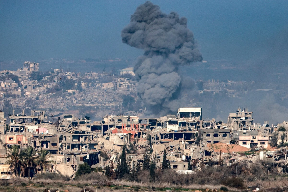 This picture taken from the Israeli side of the border with the Gaza Strip shows a smoke plume rising from explosions above destroyed buildings in the northern Gaza Strip on January 13, 2025 amid the ongoing war between Israel and Hamas. (AFP)