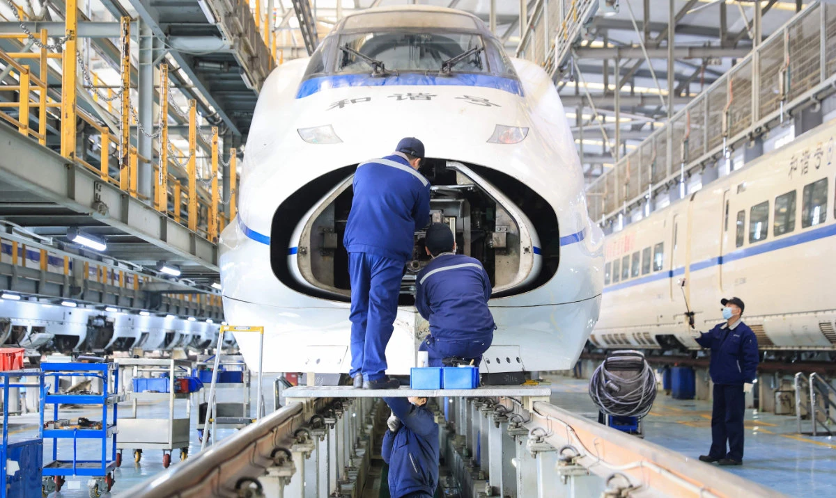 Mechanics checking a bullet train at a maintenance center in preparation for the upcoming Spring Festival travel rush ahead of the Lunar New Year of Snake in Nanjing on Monday. (AFP)