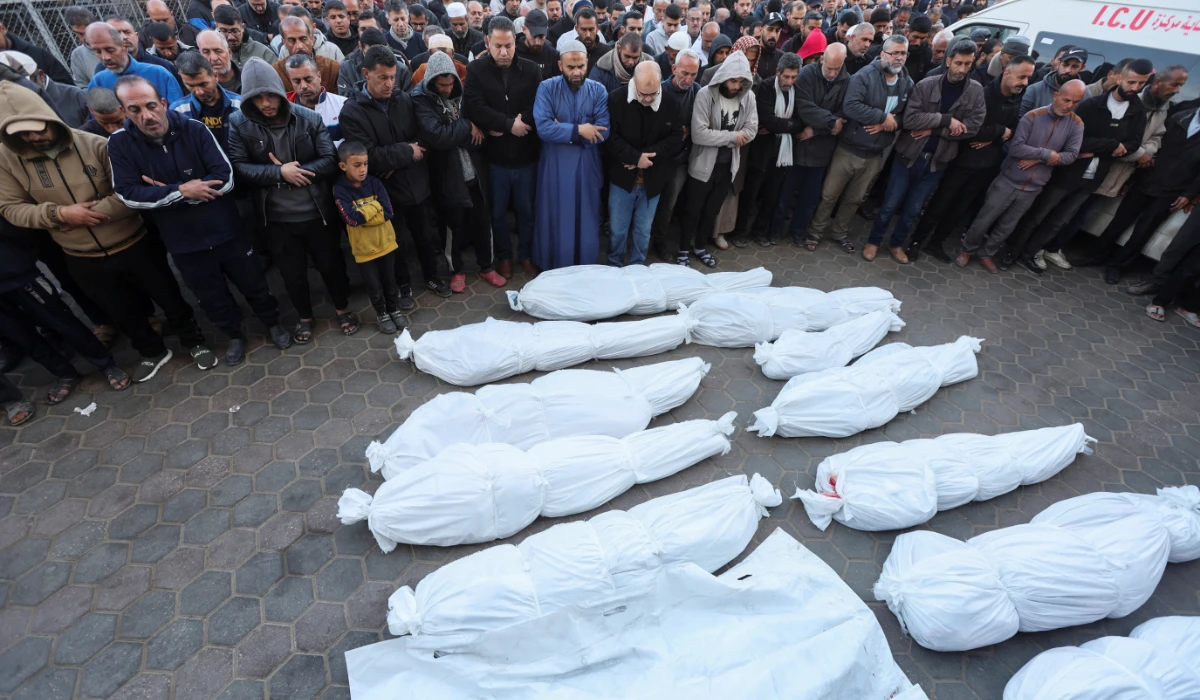Mourners perform funeral prayers near the bodies of Palestinians killed in Israeli strikes, amid the ongoing conflict between Israel and Hamas, at Al-Aqsa Martyrs hospital, in Deir Al-Balah in the central Gaza Strip, January 15, 2025. (REUTERS)