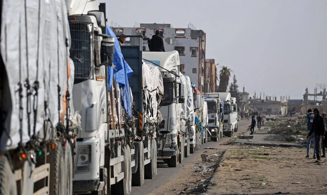 Trucks carrying humanitarian aid arrive in the Gaza Strip via the Kerem Shalom crossing, also known as Karem Abu Salem, on January 19, 2025. (AFP)