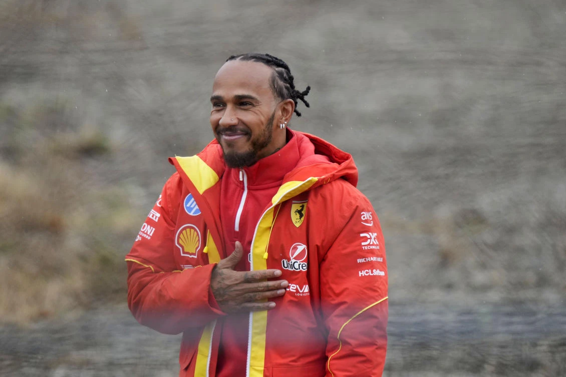 British driver Lewis Hamilton greets Ferrari fans gathered outside the track, after testing a Ferrari Formula One SF-23, in Fiorano Modenese, Italy, Jan.22, 2025. (AP)