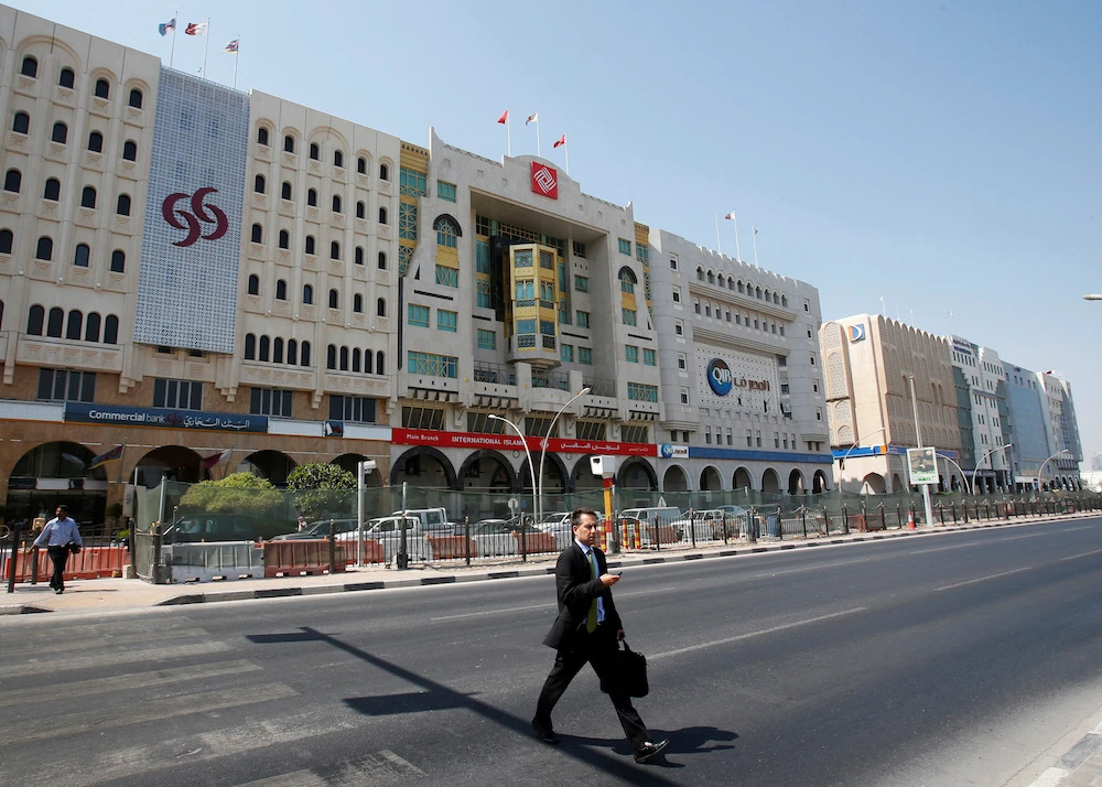 A man crosses Grand Hamad Street which hosts banks and financial institutions in Doha. File/Reuters
