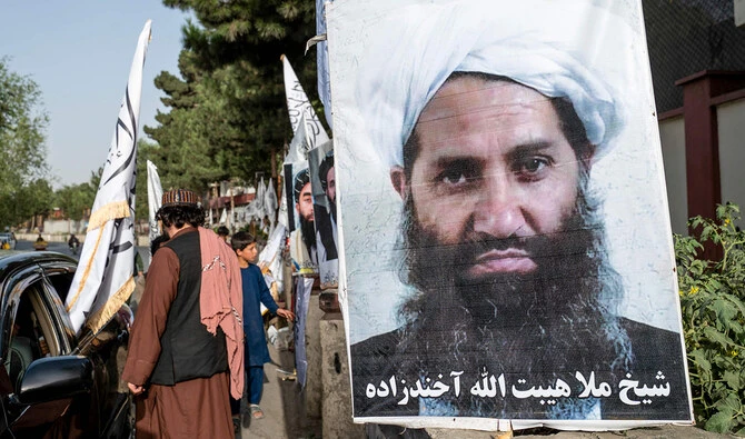 A poster of Taliban Supreme Leader Hibatullah Akhundzada is seen along a road in Kabul on August 14, 2023. (AFP/File)