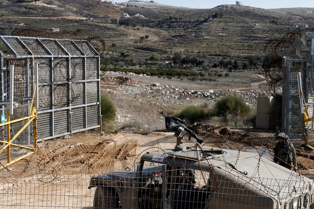 An Israeli army vehicle patrols near the fence leading into the UN-patrolled buffer zone, which separates Israeli and Syrian forces in the Golan Heights on Jan. 5, 2025. (AFP)
