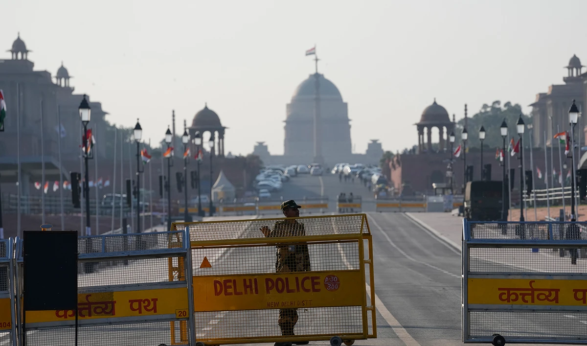 An Indian paramilitary soldier stands guard near a police barricade on Kartavya Path in New Delhi on January 23, 2025. (AP)