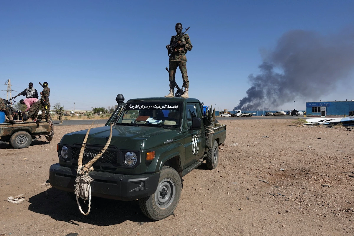 Sudan army soldiers celebrate the retaking an oil refinery in North Bahri on Saturday. (Reuters)