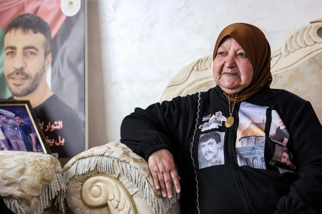 Latifa Abu Hamid, 75, mother of five Palestinian prisoners, one of whom died while in Israeli custody, gives an interview at her home in Ramallah in the occupied West Bank on January 21, 2025. (AFP)