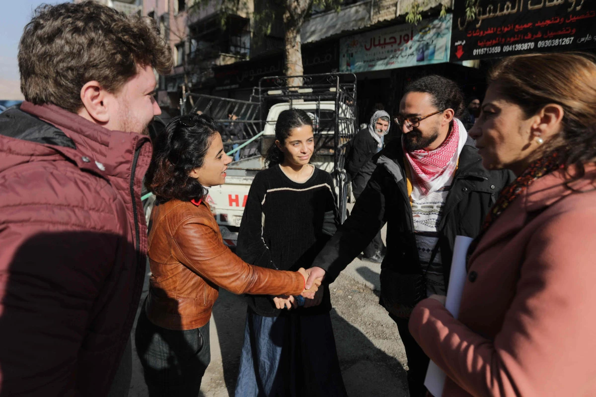 Syrian activist and former refugee Wafa Mustafa (C) talks to participants after a demonstration in Damascus on January 1, 2025. (AFP)