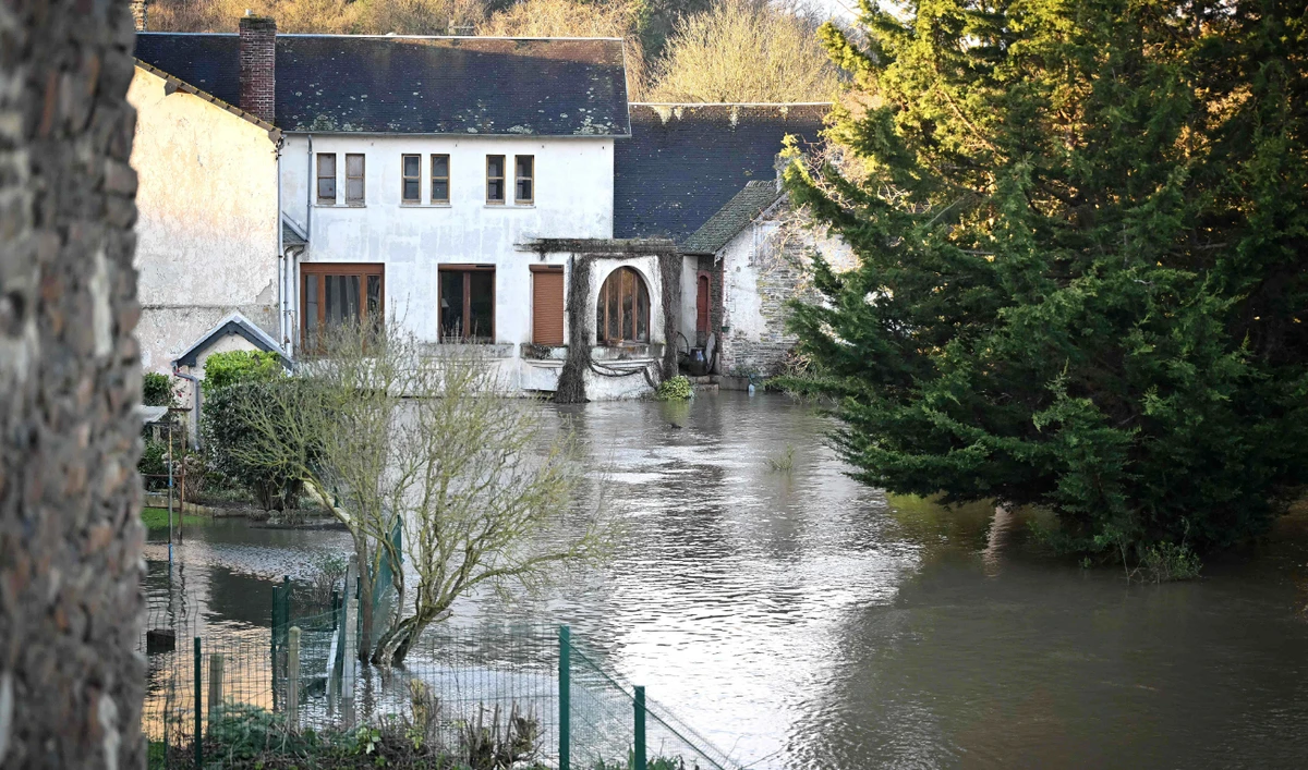 Gardens and streets are submerged in flood water following Storm Hermina, in Caumont-sur-Oren, northwestern France, on Monday. (AFP)