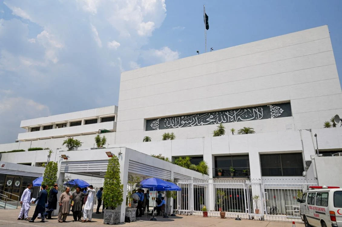 People stand outside the Parliament house in Islamabad on June 26, 2024. (File/AFP)