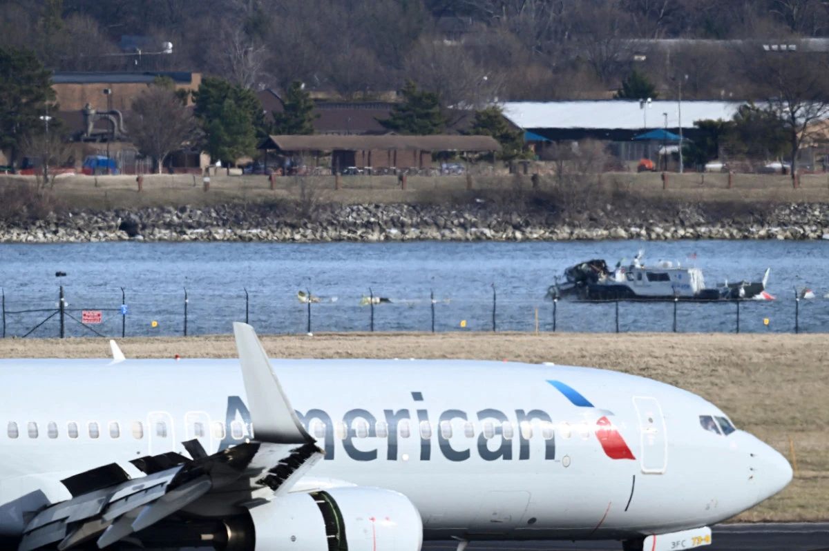 A police boat gathers wreckage along the Potomac River of American Airlines flight 5342, which crashed into the river after colliding with a US Army helicopter on approach to Reagan National Airport near Washington, DC, on January 30, 2025. (AFP)