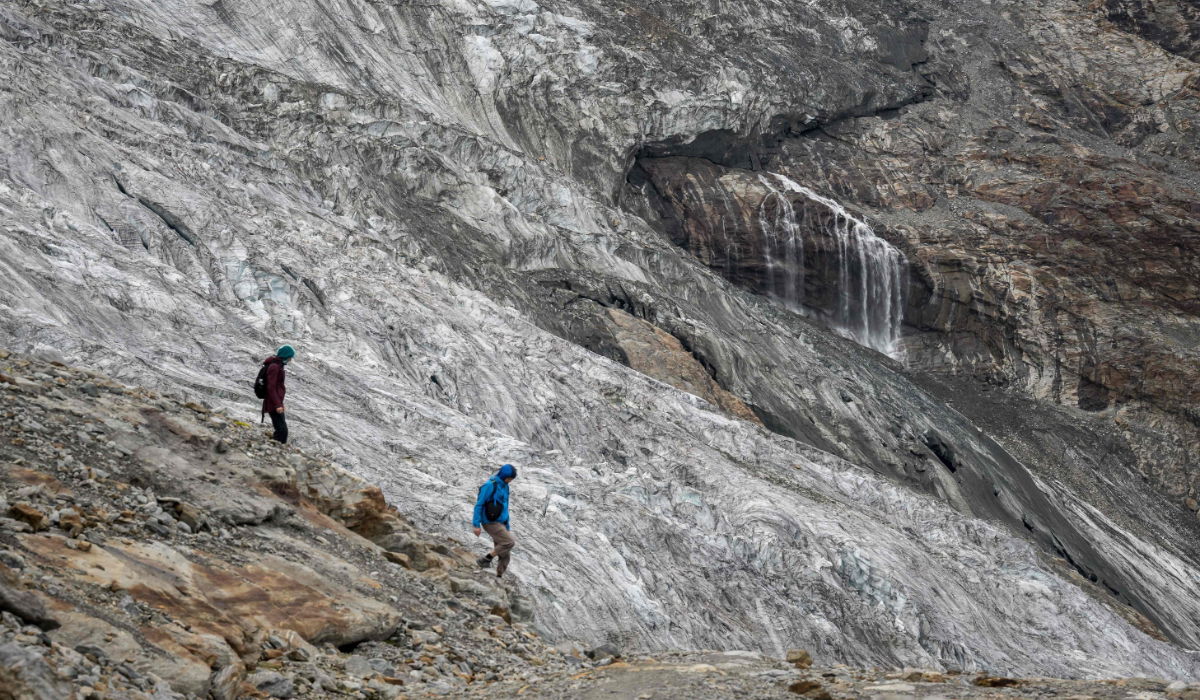 Hikers are seen walking next to the Fee Glacier (German: Feegletscher) melting above the Swiss alpine resort. (AFP)