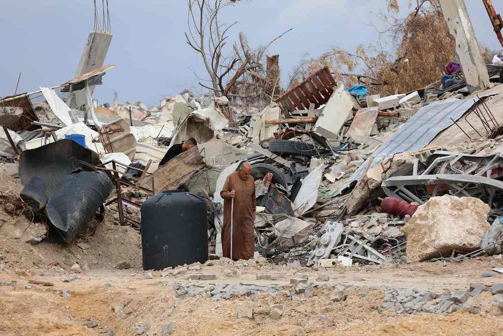 A displaced Palestinian inspects the damage to his home in Gaza City’s southern Al-Zeitoun on Feb. 9, 2025. (AFP)