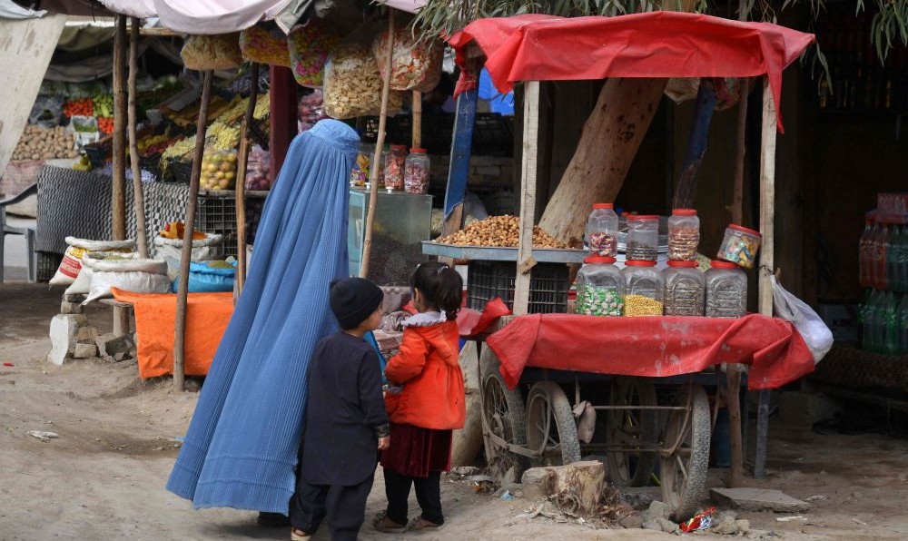 An Afghan woman and her children at a roadside market in Kandahar, Feb. 9, 2025. (AFP)