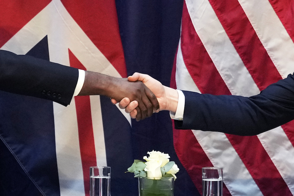US Vice-President JD Vance, right, and UK’s top envoy David Lammy shake hands on the sidelines of the Munich event. (AP)