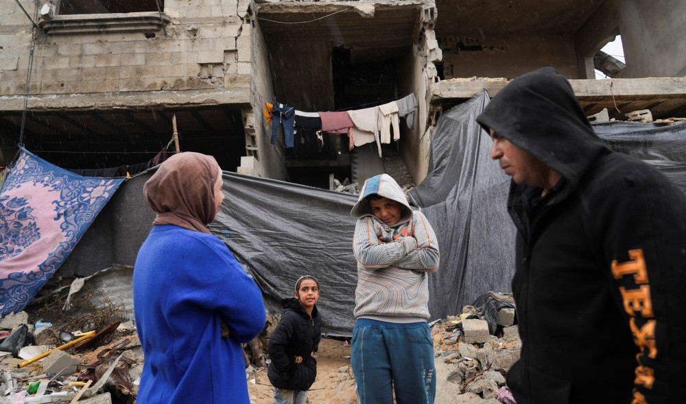 Palestinians stand outside their home, which was struck by an Israeli airstrike, Beit Lahiya, Gaza, Feb. 21, 2025. (AP Photo)