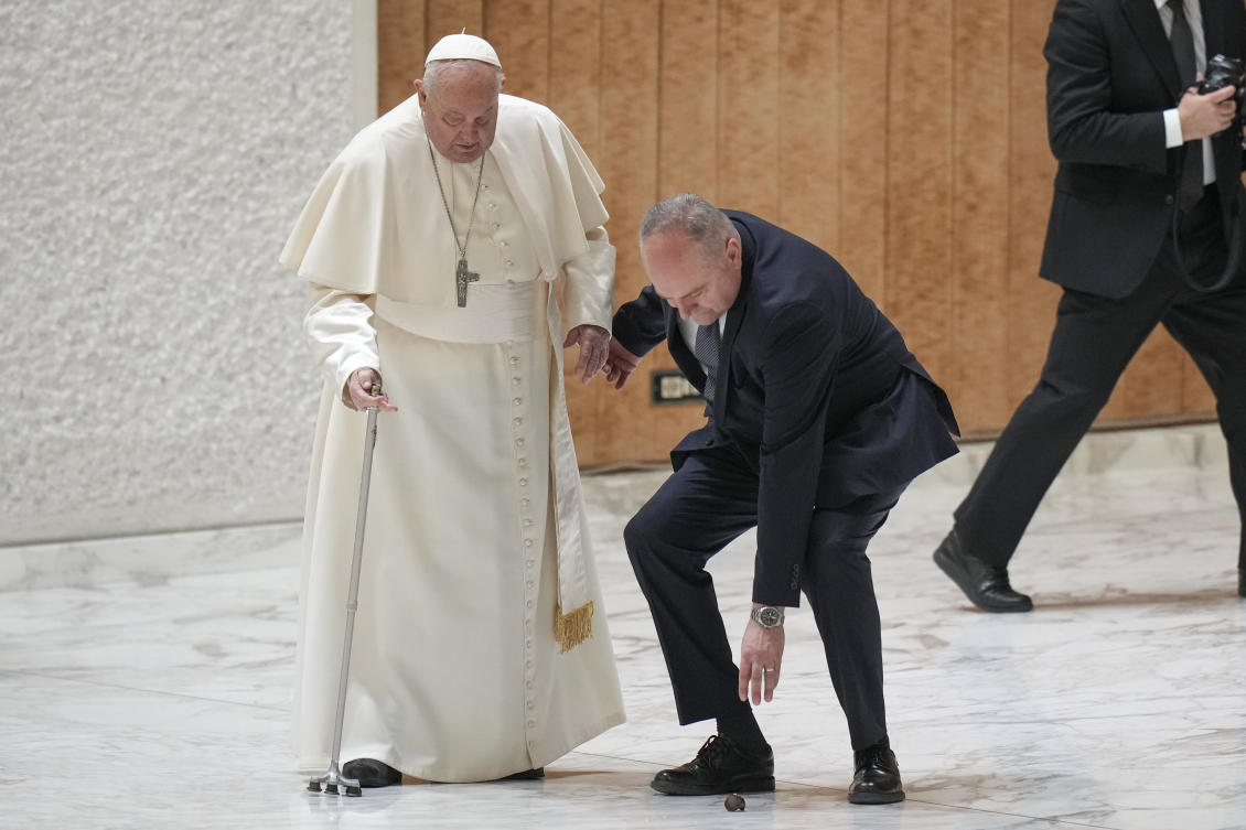 Pope Francis’ aide picks up the the handle of the Pope’s walking stick after it snapped as he was arriving for a Jubilee audience in the Pope Paul VI hall at the Vatican on Feb. 1, 2025. (AP)