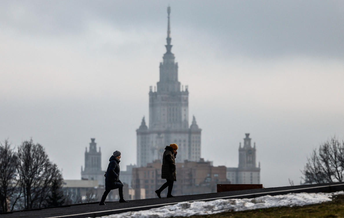 Women walk in Victory Park with the building of the Moscow State University in the background during warm winter weather in Moscow, Russia, January 31, 2025. (Reuters)