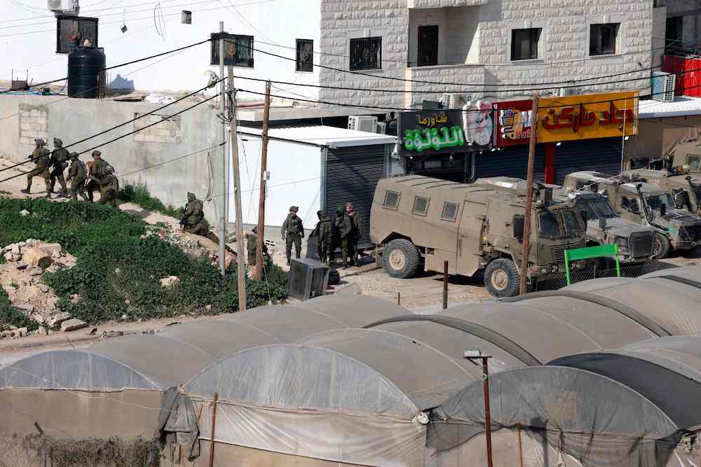 Lord Hermer wrote a chapter in the book on ways that Palestinian victims could use British courts to sue weapons firms that sold arms to Israel. (AFP file photo)