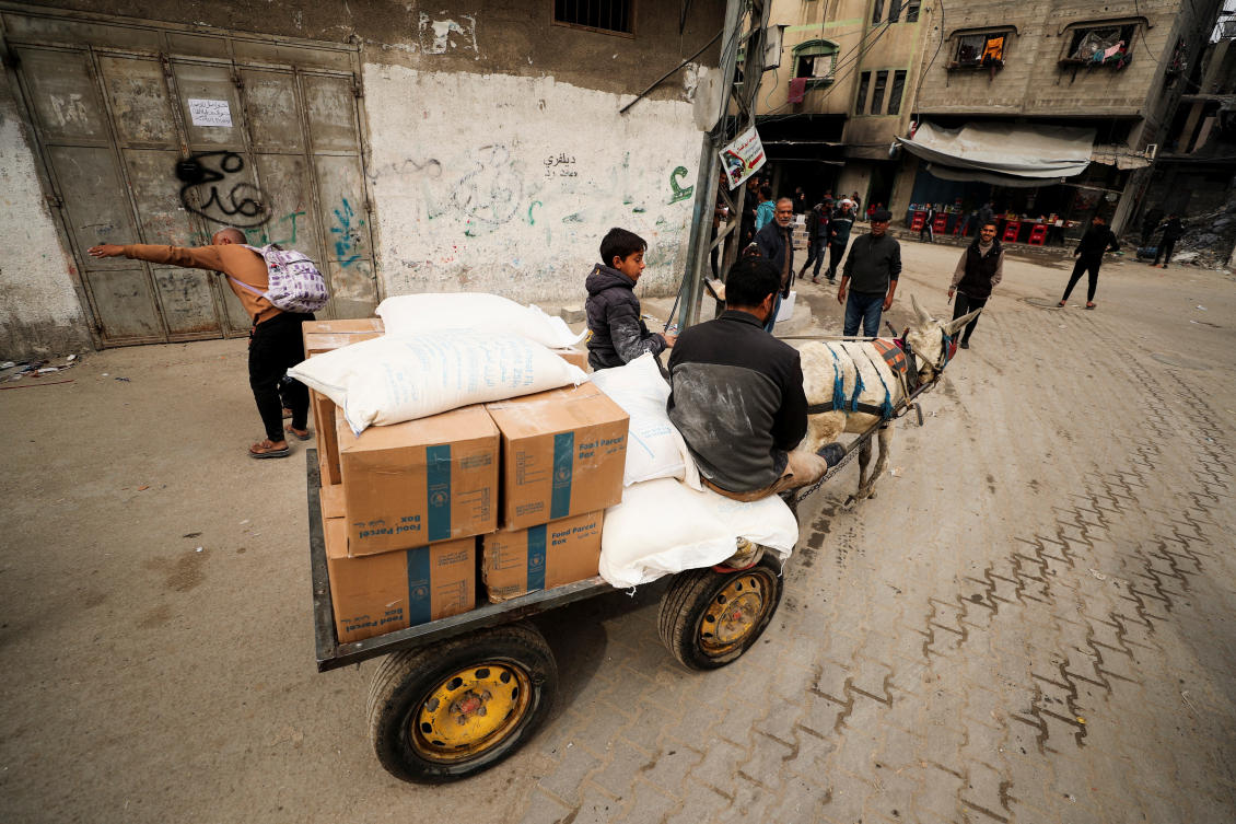 Palestinians transport aid supplies on an animal-drawn cart, amid a ceasefire between Hamas and Israel, in Gaza City, February 3, 2025. (Reuters)