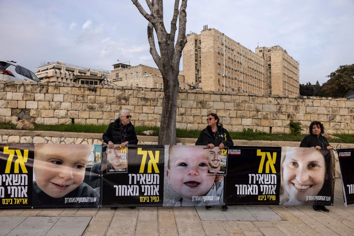 Supporters of Israeli hostages held captive in the Gaza Strip since the Oct. 7, 2023 attacks hold images of the Bibas family as they protest in front of prime minister’s office in Jerusalem on February 3, 2025. (AFP)