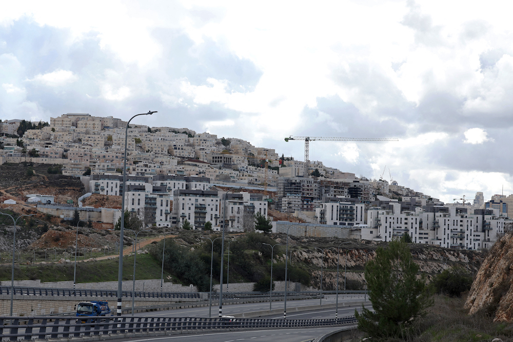 Above, construction cranes at Ramat Shlomo, a Jewish settlement in the Israeli-annexed eastern sector of Jerusalem on Jan. 24, 2025. (AFP)
