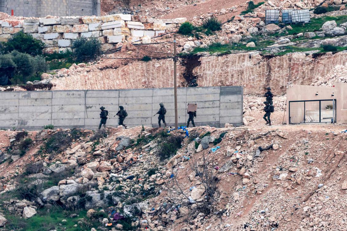 Israeli army soldiers walk during a military operation in the Jenin camp for Palestinian refugees in the north of the occupied West Bank on Feb. 3, 2025. (AFP)