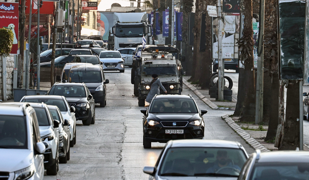 Israeli army vehicles drive during a military raid in Ramallah in the occupied West Bank, on February 4, 2025. (AFP)