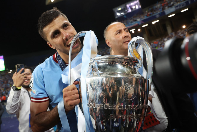 Manchester City’s Rodri bites the trophy as he celebrates winning the Champions League. (Reuters/File)