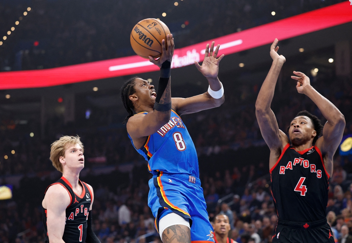 Oklahoma City Thunder forward Jalen Williams goes up for a basket between Toronto Raptors guard Gradey Dick (1) and forward Scottie Barnes (4) during the first quarter of an NBA game Friday at Paycom Center. (USA TODAY Sports)