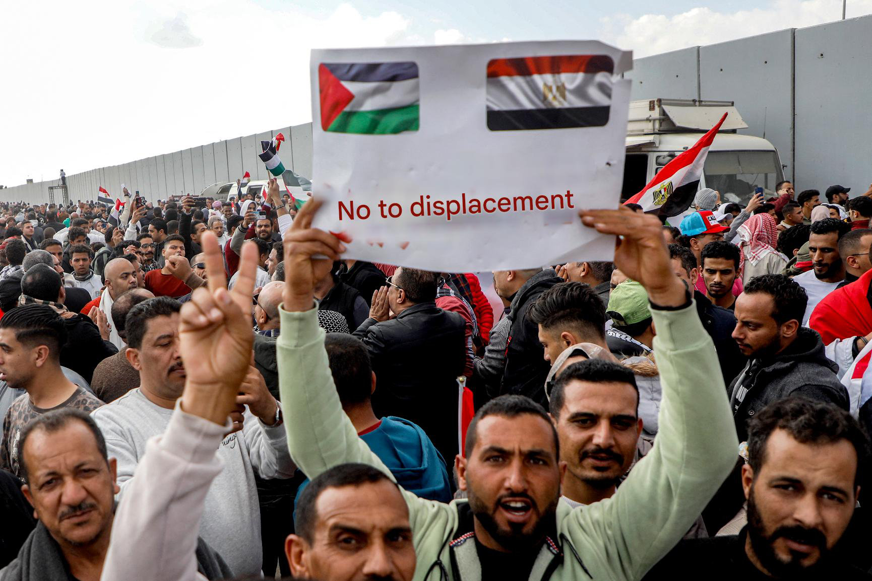 Demonstrators gather outside the Egyptian side of the Rafah border crossing with the Gaza Strip on January 31, 2025 to protest against a plan floated by US President Donald Trump to move Palestinians from the Gaza Strip to Egypt and Jordan. (AFP)