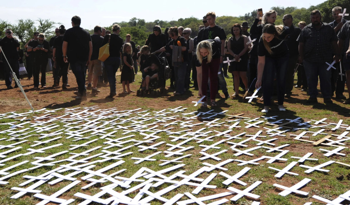 People place white crosses representing farmers killed in the country at a ceremony at the Vorrtrekker Monument in Pretoria, South Africa, on Oct. 30, 2017. (AP Photo, File)
