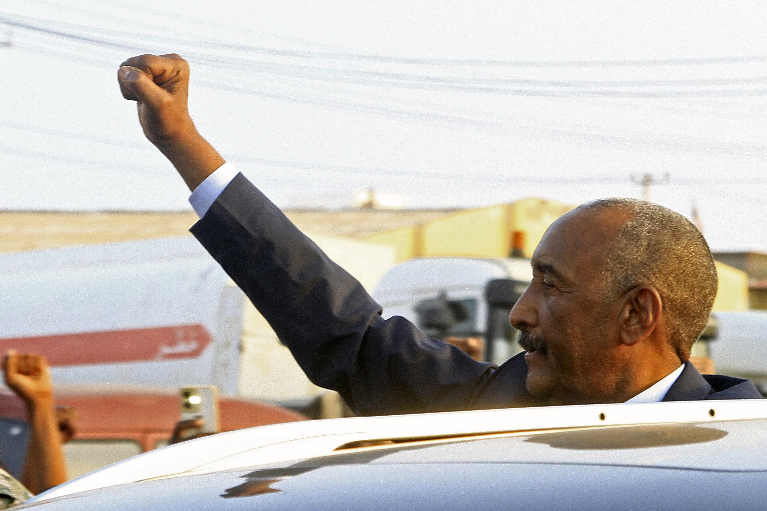 Sudan's army chief Abdel Fattah al-Burhan gestures to people waiting to greet him along a street in Port Sudan, Jan. 14, 2025. (AFP)