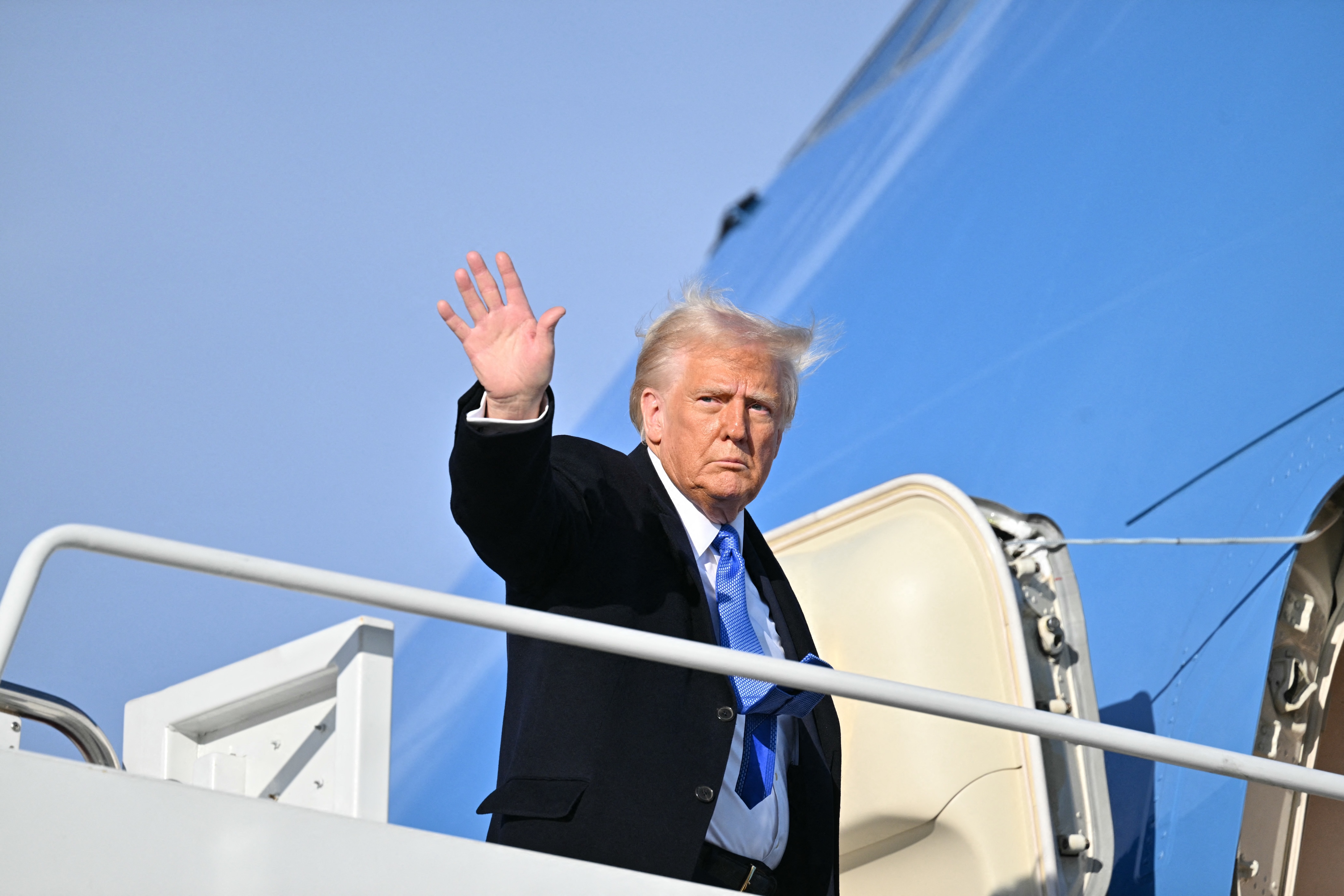 US President Donald Trump waves as he boards Air Force One at Joint Base Andrews in Maryland, Feb. 7, 2025. (AFP)