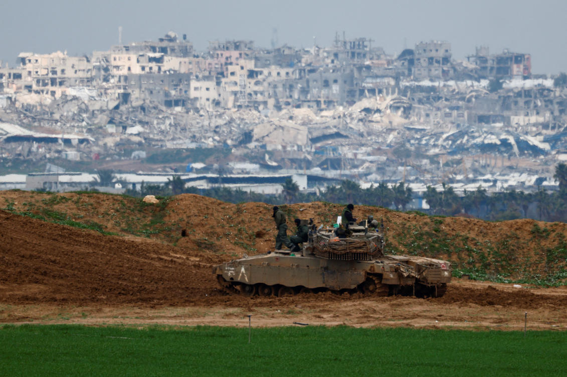 Israeli soldiers gather on top of a tank on the Israeli side of the border with Gaza, as seen from Israel, February 11, 2025. (Reuters)