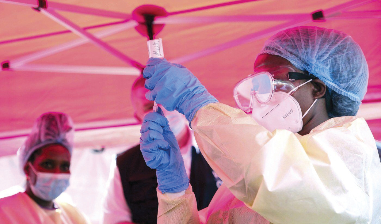 A health worker prepares to administer a vial of a vaccine against the Sudan strain of Ebola during a trial at Mulago Hospital in Kampala. (AP)