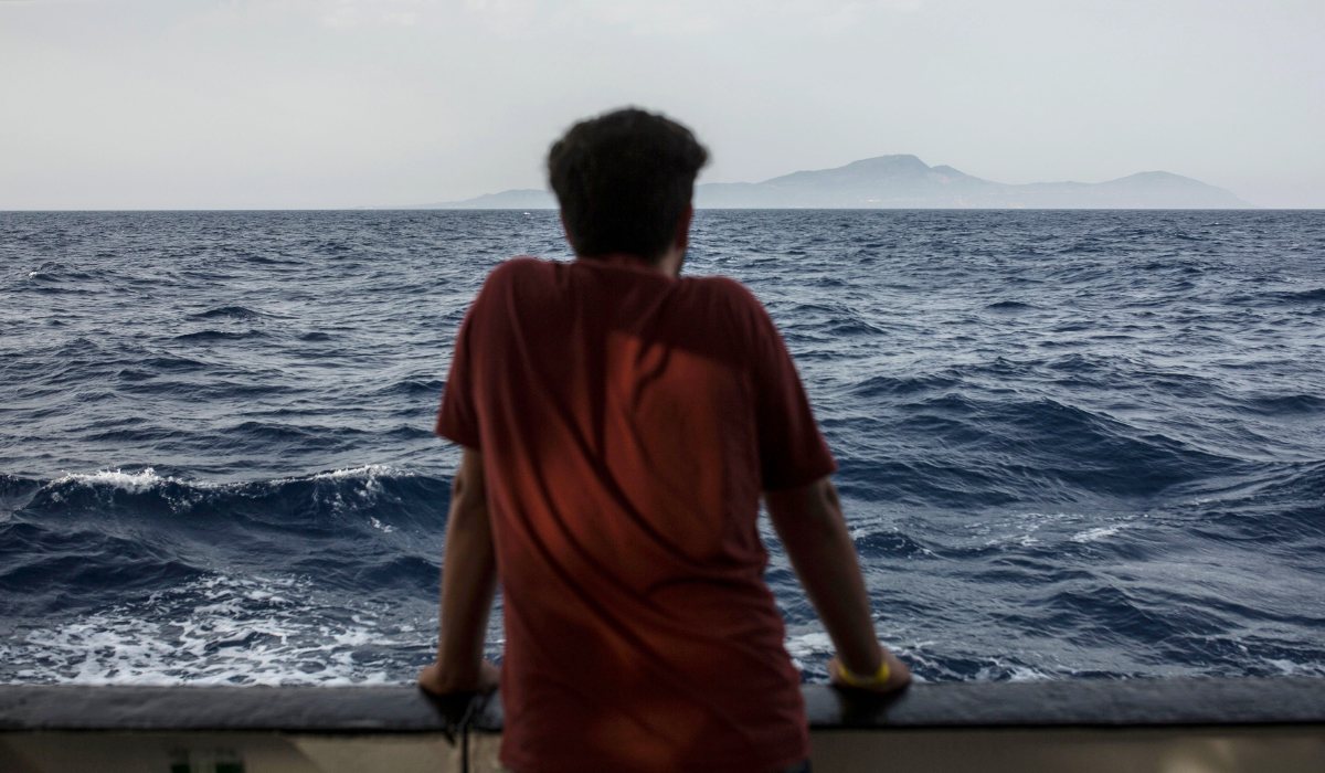 A migrant looks at the sea from the deck of the boat of the NGO Proactiva Open Arms on July 1, 2018. (AFP)
