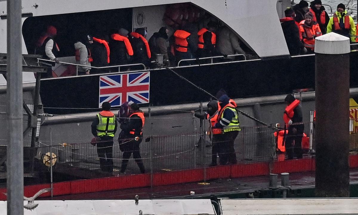 Migrants picked up at sea attempting to cross the English Channel from France, disembark from Border Force vessel ‘Typhoon’ after it arrived at the Marina in Dover, southeast England, on Feb. 9, 2025. (AFP)