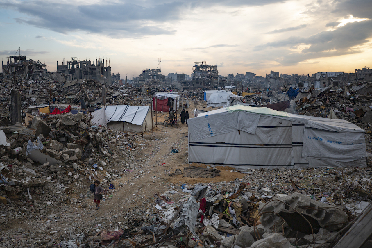Palestinians walk in the destruction caused by the Israeli air and ground offensive in Jabaliya, Gaza Strip, Tuesday, Feb. 11, 2025. (AP)