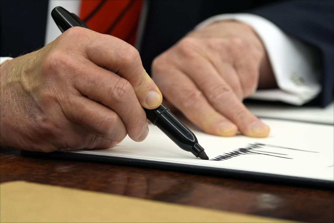 President Donald Trump signs an executive order in the Oval Office at the White House, Monday, Feb. 10, 2025, in Washington. (AP)