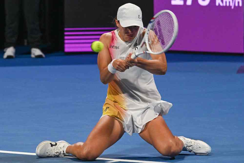 Iga Swiatek of Poland returns the ball to Linda Noskova of the Czech Republic during their 2025 WTA Qatar Open match at the Khalifa International Tennis Complex in Doha on Wednesday. (AFP)