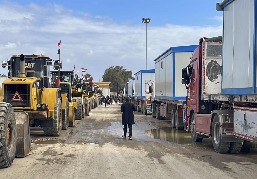 Bulldozers and trucks carrying caravans wait to enter Gaza at the Rafah border crossing between Egypt and the Gaza Strip, Thursday, Feb. 13, 2025. (AP)