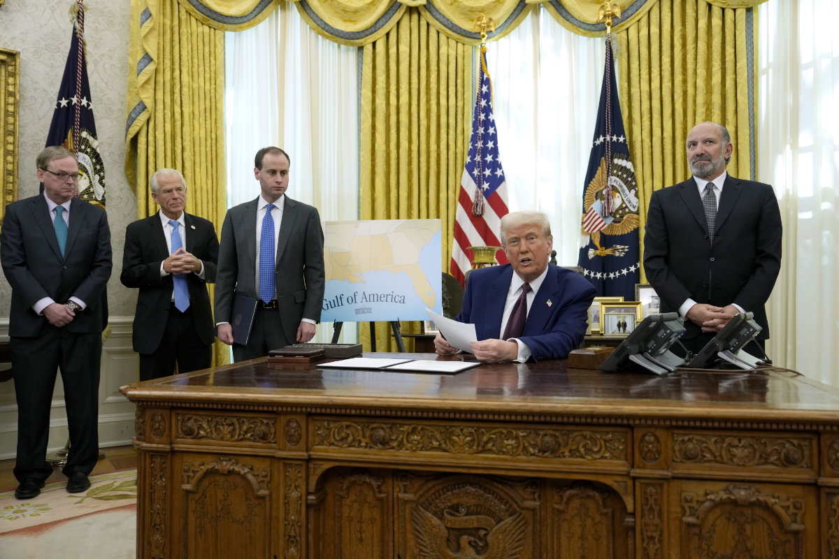 President Donald Trump speaks to reporters before signing an executive order as his aides watch at the White House in Washington on Feb. 13, 2025. (AP)